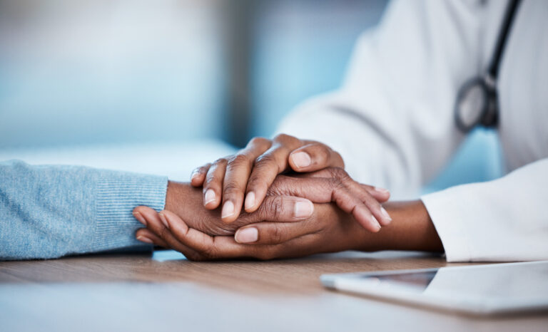 Doctor and patient closeup, holding hands and consultation support, healthcare services and sad news, test results or help. Clinic, medical professional or black people consulting, helping and advice.